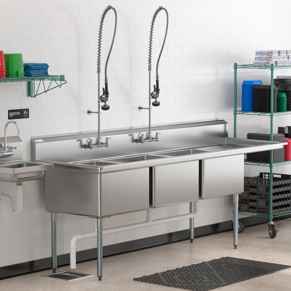 A stainless steel Regency three compartment sink with a right drainboard.