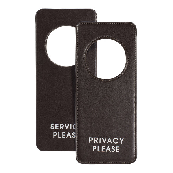 A pair of brown faux leather door hangers with the words "privacy please" on them.