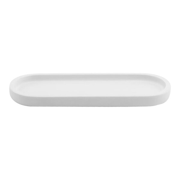 A white oval Room360 amenity tray with a long handle.