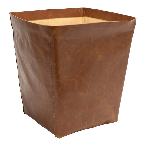 A Room360 brown faux leather wastebasket.