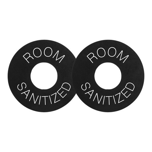 A black circle with the words "Room Sanitized" in white.