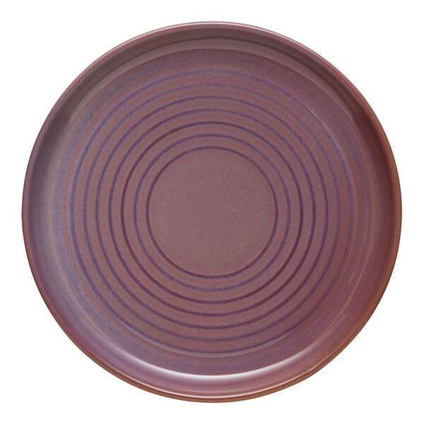 A Libbey mauve terracotta stoneware plate with a circular spiral pattern.