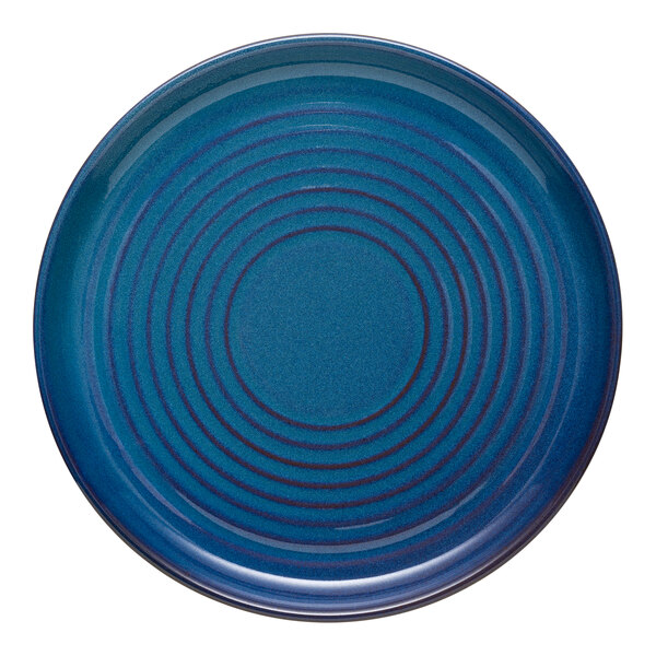 A blue Libbey terracotta plate with a spiral pattern.