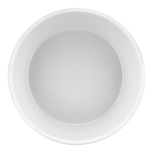 A white round porcelain souffle dish with a white surface.