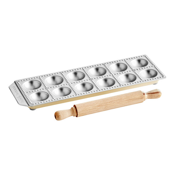 A Matfer Bourgeat ravioli mold tray with a wooden rolling pin.