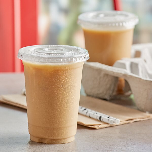 Two Choice clear plastic cups of coffee with straws.