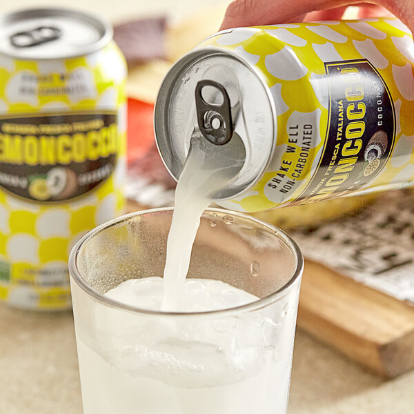 A person pouring Lemoncocco Lemon Coconut Beverage from a can into a glass.