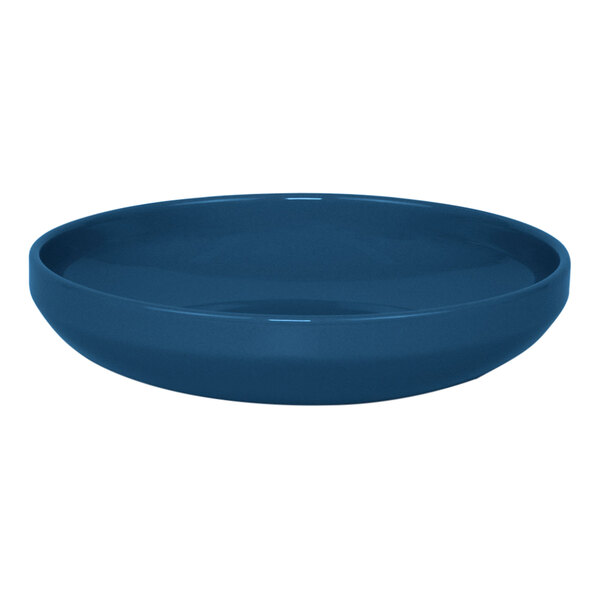 A close up of a blue Front of the House Bevel porcelain bowl with a white background.