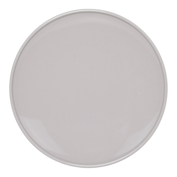 A close-up of a Front of the House Bevel round porcelain plate with a white border.