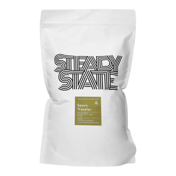 A white bag of Steady State Space Traveler whole bean coffee with black text and a black and white logo.