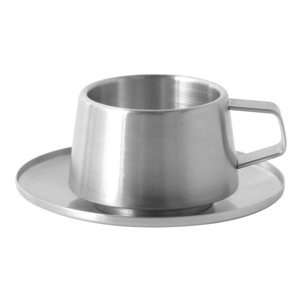 A Front of the House stainless steel cup on a saucer.