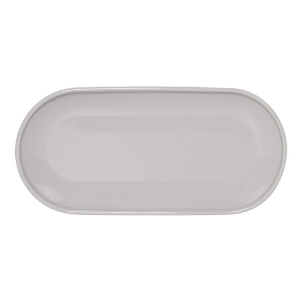 A white oval porcelain plate with a beveled edge.