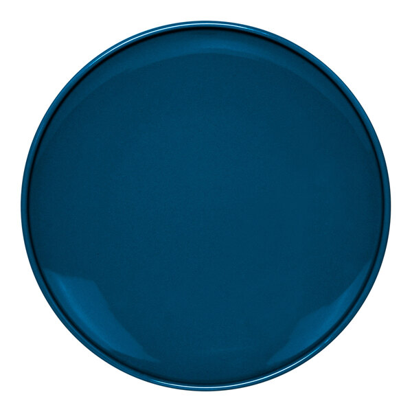 A close-up of a blue Front of the House Bevel porcelain plate with a white center.