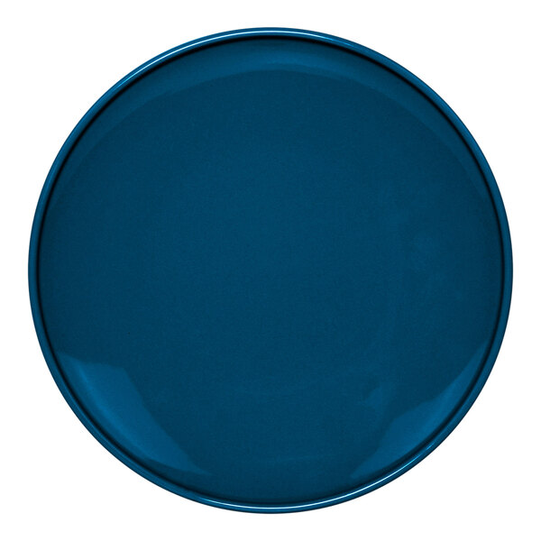 A close-up of a blue Front of the House Bevel porcelain plate with a white border.