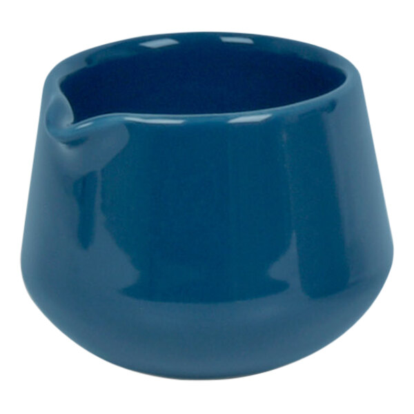 A blue ceramic pourer with a handle.