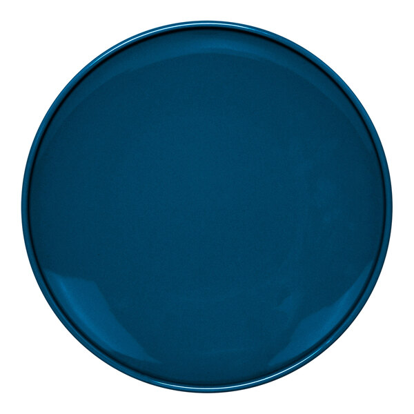 A close-up of a blue Front of the House Bevel porcelain plate with a white border.