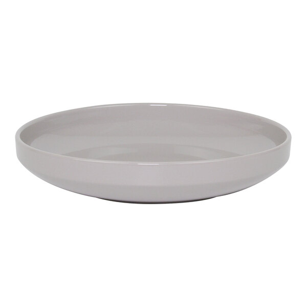 A white bowl with a beveled edge on a white surface.