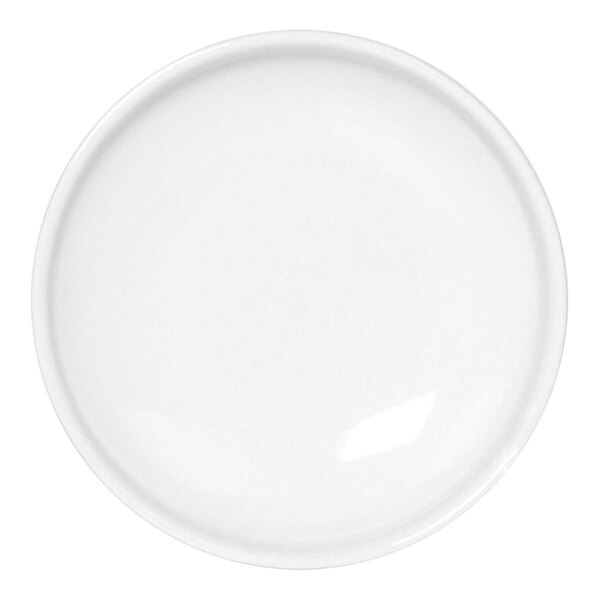 A white porcelain ramekin with a beveled edge on a white surface.