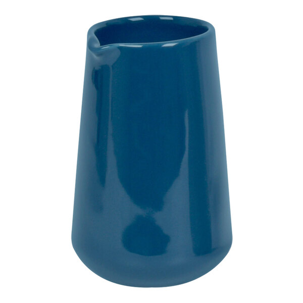 A blue porcelain pourer with a handle.