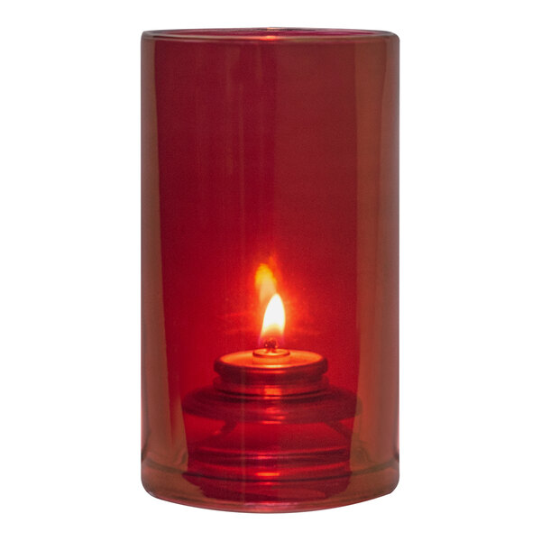 A Hollowick ruby luster glass candle holder with a lit red candle.
