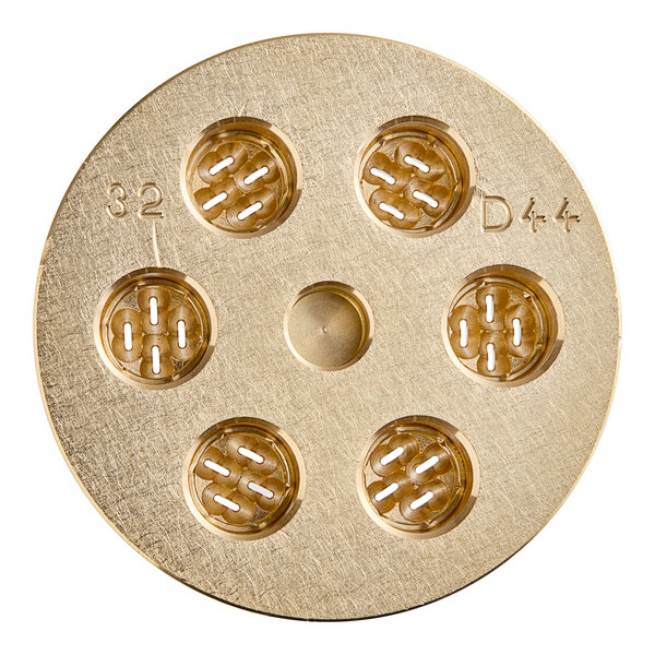 A circular gold pasta die with holes in it.