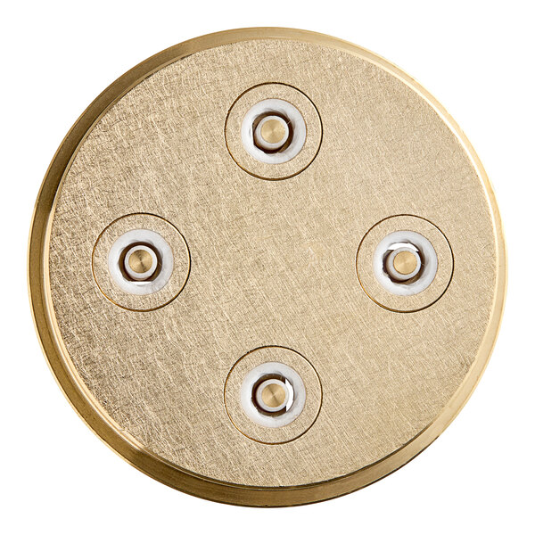 A circular gold pasta die with four holes.