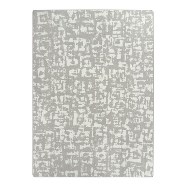 A white rectangle area rug with abstract grey block print designs.