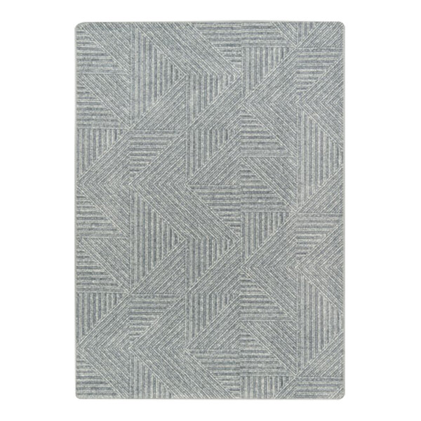 A close-up of a grey and white Joy Carpets Above Board area rug with geometric patterns.