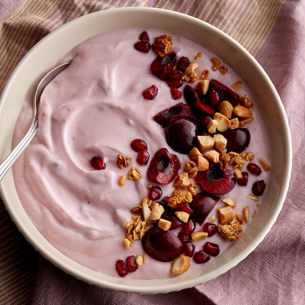 A bowl of Pequea Valley Farm black cherry yogurt with fruit and nuts.
