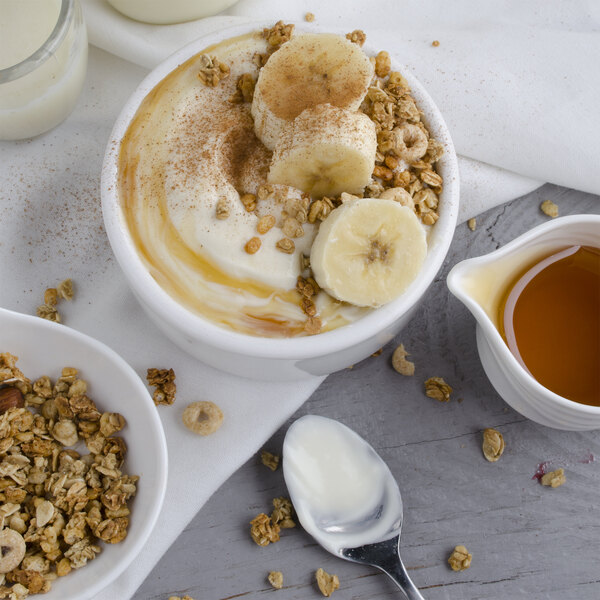 A bowl of Pequea Valley Farm vanilla yogurt with bananas and granola.