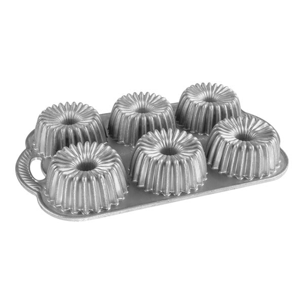 A Nordic Ware metal cake pan with six ring-shaped molds.