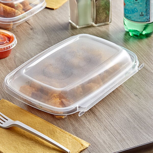 A Inline Plastics rectangular deli container with food inside and a fork.