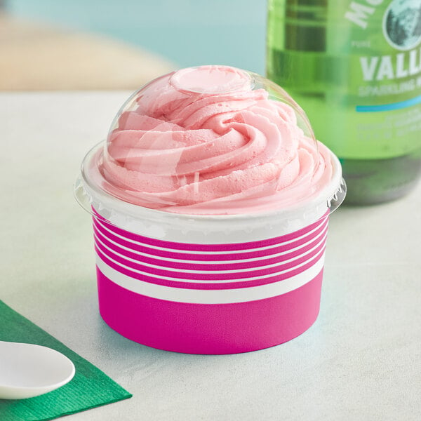 A pink frozen yogurt in a Choice paper cup with a dome lid.