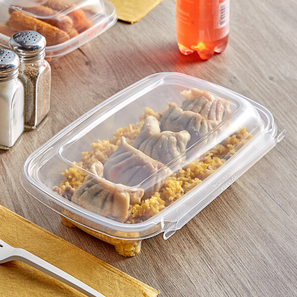 Inline Plastics Safe-T-Chef rectangular deli container with food inside and a fork.