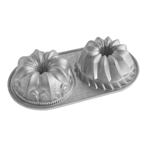 A silver Nordic Ware bundtlette cake pan with two different designs.