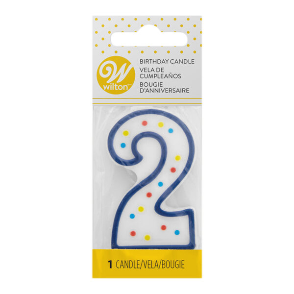 A blue and white Wilton number 2 candle with colorful dots on the package.