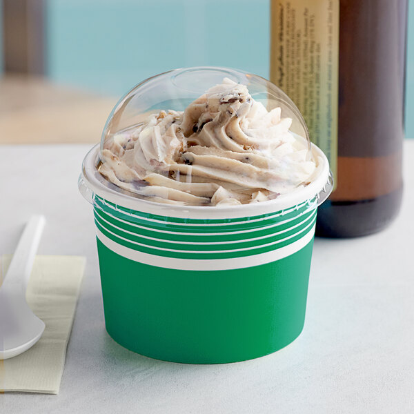 A green Choice paper cup with a dome lid filled with white and brown frozen yogurt.