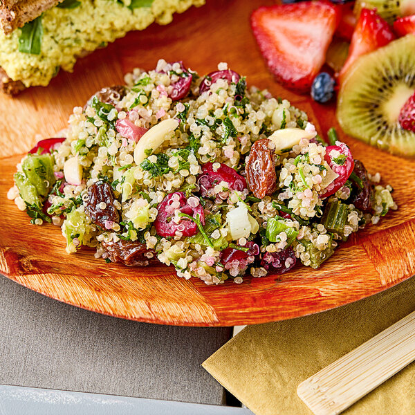 A plate of Sunneen vegan cranberry quinoa salad with fruit on it.
