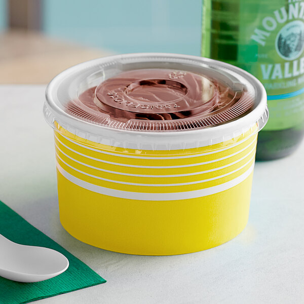 A yellow Choice paper frozen yogurt cup with a brown lid.