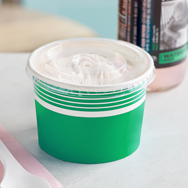 A green paper frozen yogurt cup with a flat lid.