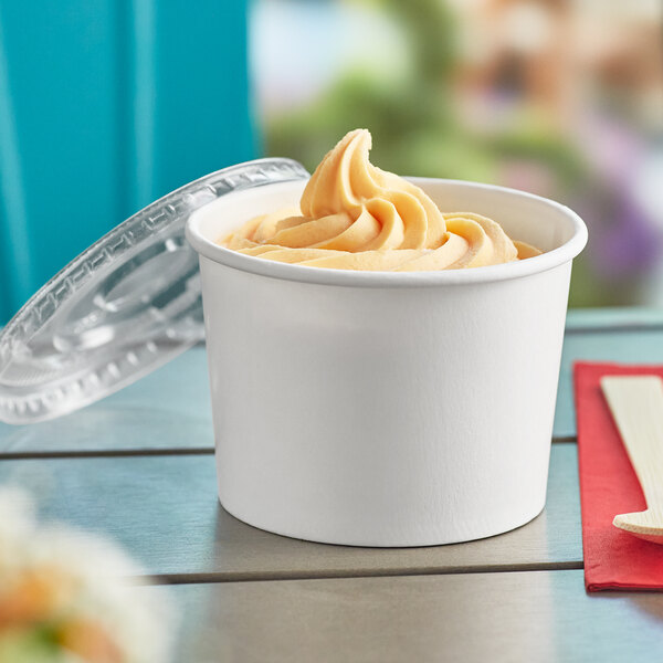 A white paper Choice food cup filled with ice cream with a flat lid.
