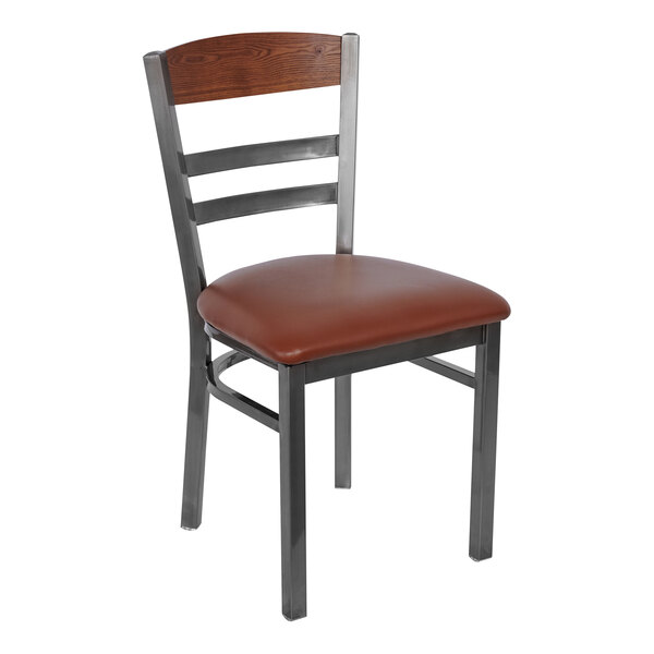 A BFM Seating metal and wood side chair with a light brown vinyl seat.