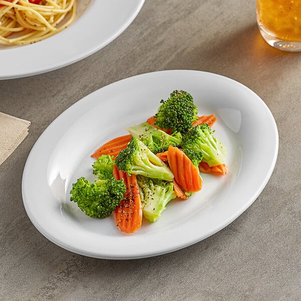 A white Acopa Foundations melamine platter with a plate of broccoli and carrots on a table.