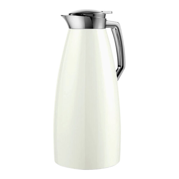 A white stainless steel coffee carafe with a metal handle.