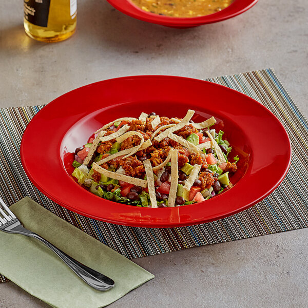 A red Acopa Foundations melamine pasta bowl with food on it.