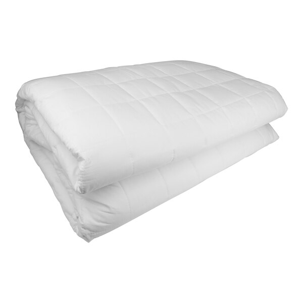 A folded white Oxford mattress pad on a white surface.