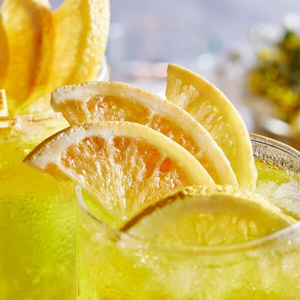 A close up of two drinks with Mixologist's Garden freeze-dried lemon slices.