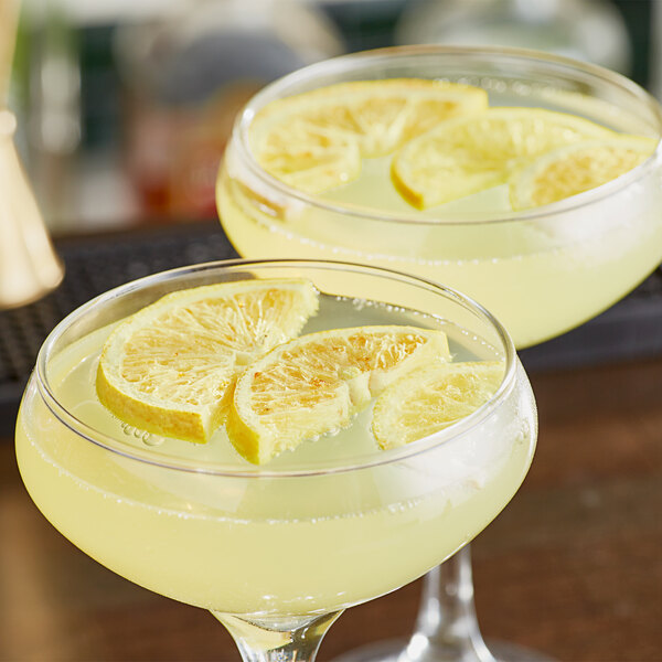 Two glasses of lemonade with Mixologist's Garden freeze-dried lemon slices on top.