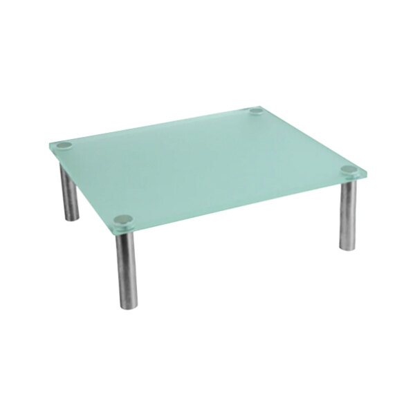 A Dalebrook clear green acrylic riser on a glass table with metal legs.