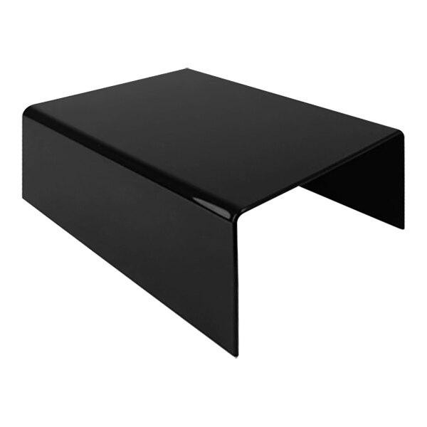 A black Dalebrook acrylic riser on a table.
